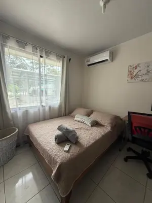 a bedroom with a bed with two towels on it at Private House with Pool 10 min from Playa Sámara in Nicoya