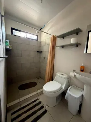 a bathroom with a toilet and a sink and a shower at Private House with Pool 10 min from Playa Sámara in Nicoya
