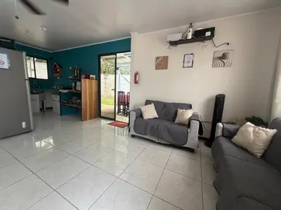 a living room with two couches and a kitchen at Private House with Pool 10 min from Playa Sámara in Nicoya