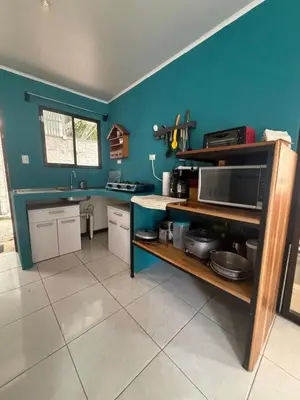 a kitchen with blue walls and a counter top at Private House with Pool 10 min from Playa Sámara in Nicoya