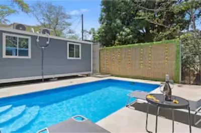 a swimming pool in a backyard with a fence at Monkey Houses in Matapalo