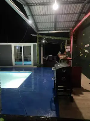 a room with a swimming pool in a building at Monkey Houses in Matapalo