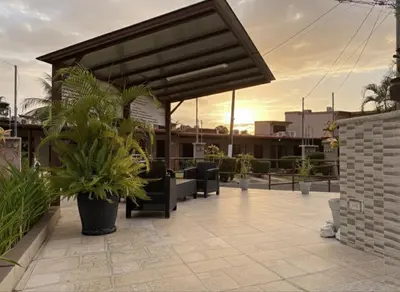 a patio with benches and plants on a building at Apartamento Jaco Park,Jaco in Jacó