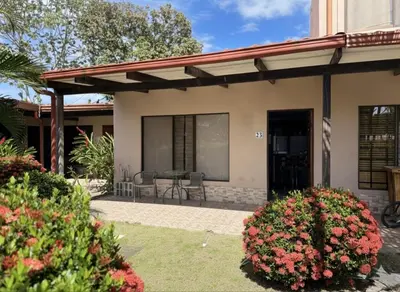 a house with a patio with a table and chairs at Apartamento Jaco Park,Jaco in Jacó