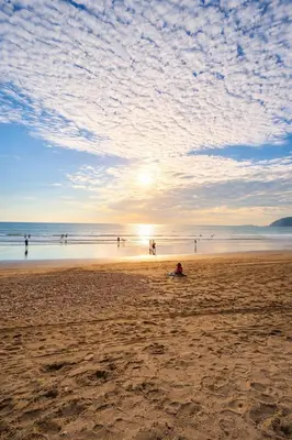 a group of people on the beach at sunset at Apartamento Jaco Park,Jaco in Jacó