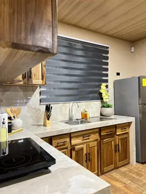 a kitchen with a sink and a refrigerator at Pura Tropic Lodge in Guayabal