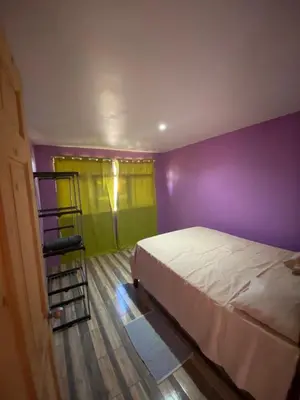 a bedroom with purple and green walls and a bed at Casa La Lima, Bagaces in Bagaces