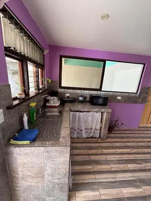 a bathroom with a sink and a purple wall at Casa La Lima, Bagaces in Bagaces