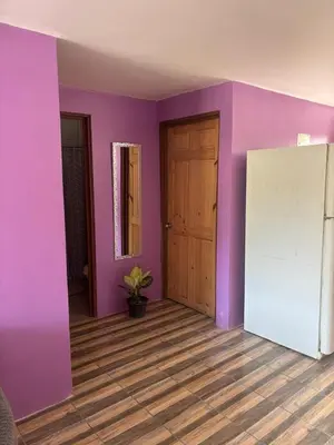 a room with purple walls and a white refrigerator at Casa La Lima, Bagaces in Bagaces