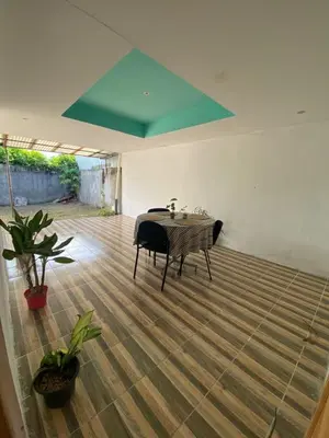 a room with a table on a wooden floor at Casa La Lima, Bagaces in Bagaces