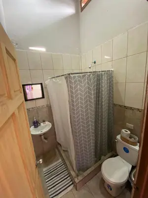 a bathroom with a shower and a toilet and a sink at Casa La Lima, Bagaces in Bagaces