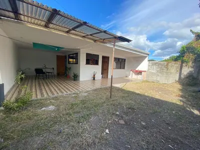 a house with a porch with a table on a deck at Casa La Lima, Bagaces in Bagaces