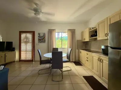 a kitchen with a table and chairs in a room at Lavinia Apartment Playa Potrero in Potrero