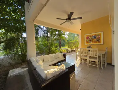 a screened in porch with a couch and a table at Lavinia Apartment Playa Potrero in Potrero
