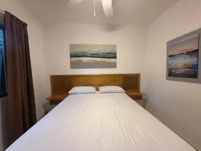 a bedroom with a large white bed with two pillows at Lavinia Apartment Playa Potrero in Potrero