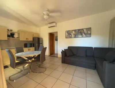 a living room with a couch and a table at Lavinia Apartment Playa Potrero in Potrero