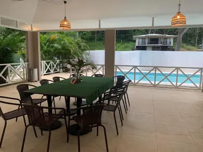 a dining room with a green table and chairs at Apartamento Manzu in Santa Cruz