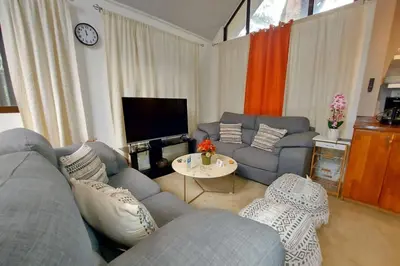a living room with a couch and a table at Cozy Jungle Loft Close to Tamarindo and Surf Beaches in Santa Rosa