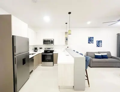 a kitchen and living room with a refrigerator and a couch at LPT15 in Villarreal