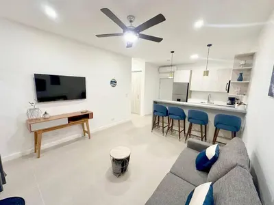 a living room with a couch and a tv and a kitchen at LPT15 in Villarreal
