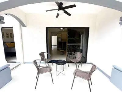 a patio with chairs and a table and a ceiling fan at LPT15 in Villarreal