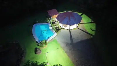 an overhead view of a swimming pool with an umbrella at Spring House in Ángeles