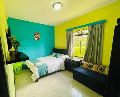 a bedroom with a bed and a window at Spring House in Ángeles