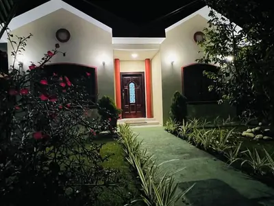 a house with a red door and some plants at Spring House in Ángeles