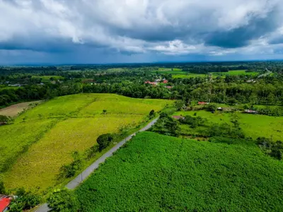 an aerial view of a green field with a road at Rio Celeste Birds Garden Apartment with Air Conditioning Comfort and Privacy in a Natural Environment 3 in Upala