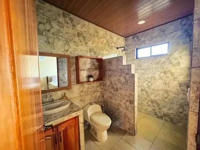 a bathroom with a toilet and a sink at Rio Celeste Birds Garden Apartment with Air Conditioning Comfort and Privacy in a Natural Environment 3 in Upala