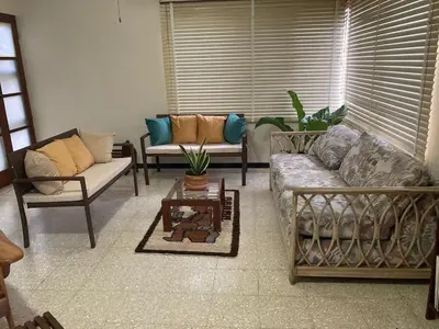 a living room with two couches and a table at CasaLinda Liberia, Guanacaste in Liberia