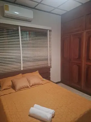 a bedroom with a bed with two towels on it at CasaLinda Liberia, Guanacaste in Liberia