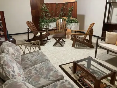 a living room with chairs and a couch and a table at CasaLinda Liberia, Guanacaste in Liberia