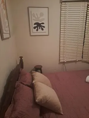 a bedroom with a bed with two pillows on it at CasaLinda Liberia, Guanacaste in Liberia