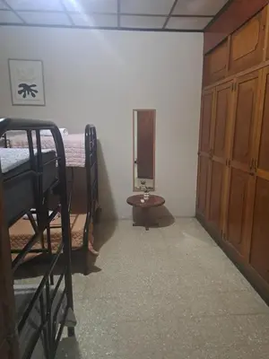 a room with two bunk beds and a table at CasaLinda Liberia, Guanacaste in Liberia
