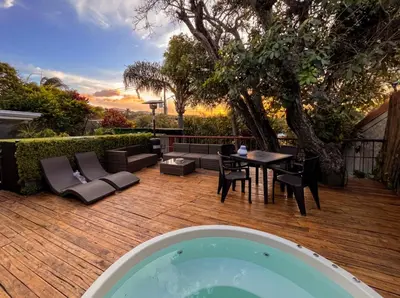 a backyard with a pool and a table and chairs at Oasis Lodge in La Asunción