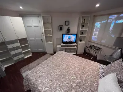 a bedroom with a bed and a television in it at Oasis Lodge in La Asunción