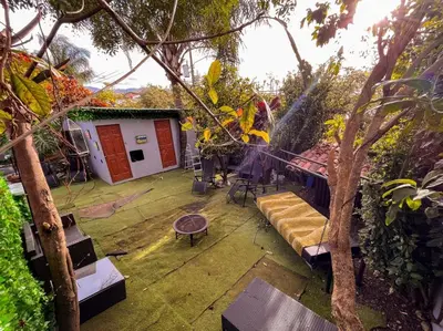 a house with a patio with a couch and a fire pit at Oasis Lodge in La Asunción