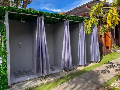 a room with purple curtains on the side of a house at Oasis Lodge in La Asunción