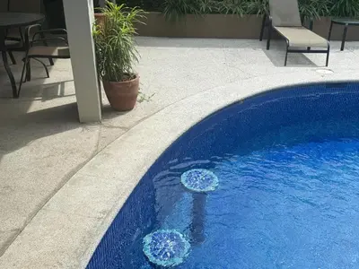 a blue swimming pool with two blue balls in it at Monaco Condominiums Unit 7 Luxury Pool View Condo 3BR 2BA - Walk to the Beach, Shopping, Tours in Jacó