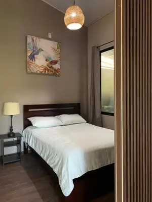 a bedroom with a bed and a lamp and a window at Casa Dama Santa María de Dota in Santa María