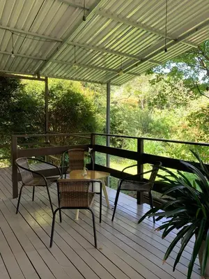 a deck with chairs and tables and a pergola at Casa Dama Santa María de Dota in Santa María