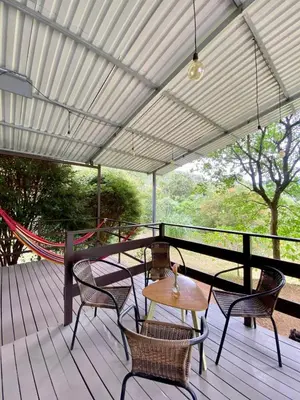 a patio with chairs and a table on a deck at Casa Dama Santa María de Dota in Santa María