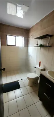 a bathroom with a toilet and a sink at Casa Matapalo Guanacaste in Matapalo