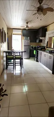 a kitchen with a table and a tableasteryasteryasteryasteryasteryasteryasteryastery at Casa Matapalo Guanacaste in Matapalo