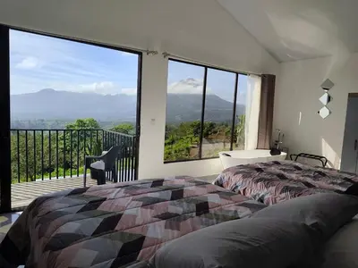 a bedroom with a bed and a large window at Villas Altos de el Arenal # 2 in Monterrey
