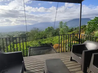 a balcony with chairs and a view of the mountains at Villas Altos de el Arenal # 2 in Monterrey