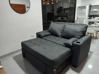 a gray couch in a living room with a mirror at Villas Altos de el Arenal # 2 in Monterrey