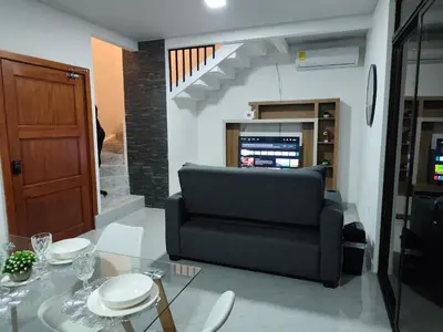 a living room with a chair and a table at Villas Altos de el Arenal # 2 in Monterrey