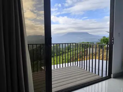 a door to a balcony with a view of a mountain at Villas Altos de el Arenal # 2 in Monterrey